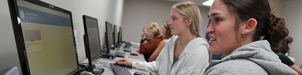 students using computers in a classroom