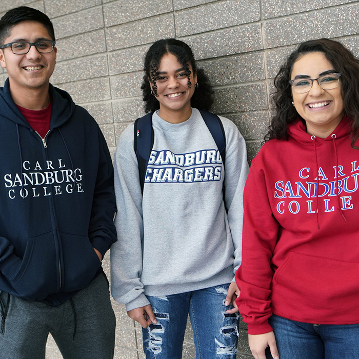 three students wearing Sandburg gear.