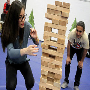 two students playing large Jenga game.