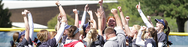 softball team in a group cheering.